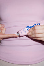 Peau Moisturising Crème 50ml tube on a soft pink background, fragrance-free and vegan skincare.