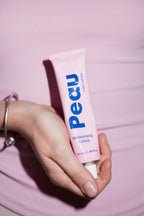 Close-up of Peau Moisturising Crème being applied, showing the lightweight texture of the barrier-repair formula.